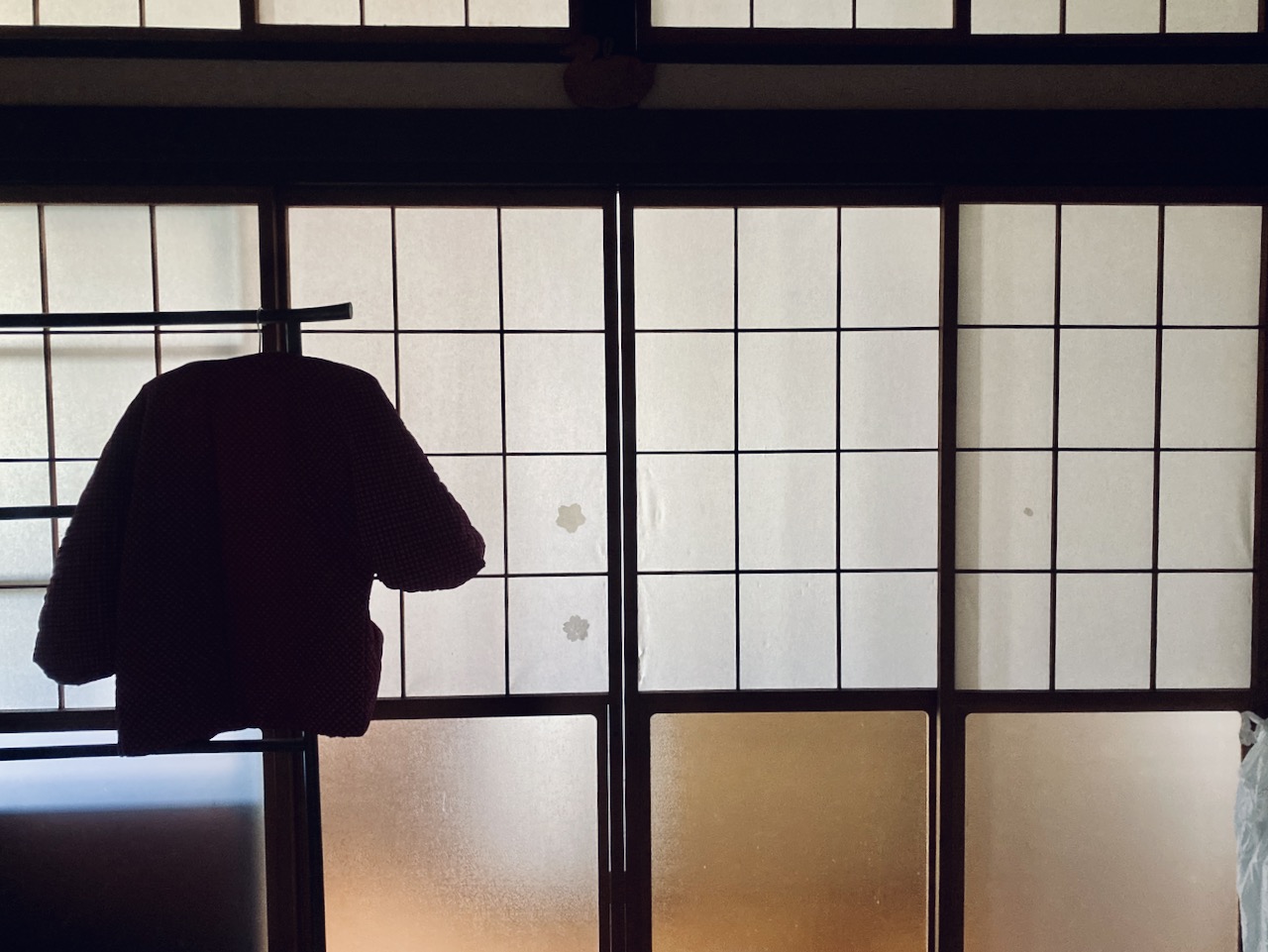 room in morninglight with kimono hanging in front of the window